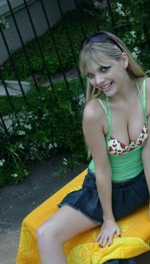 Young blonde Jana Jordan exposes her pretty bra and panties by a swimming pool - Jordan on dollser.com