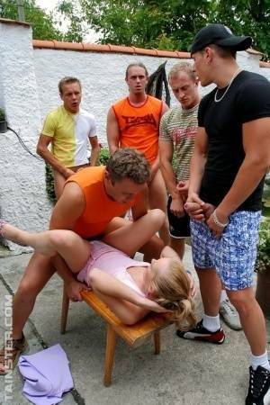 Clothed Euro slut takes on five men during a gangbang on patio on dollser.com