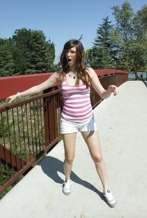 Flexible babe in shorts Holly Michaels shows her sports body outdoor on dollser.com