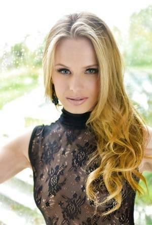 Blonde babe model Jillian Janson strutting outdoors in black bodystocking on dollser.com