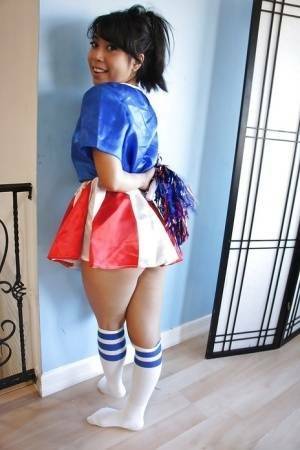 Tiny Asian cheerleader May Lee posing in cute uniform and socks on dollser.com