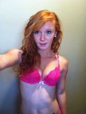 Natural redhead Alex Tanner slips off her pink lingerie set for nude selfies on dollser.com