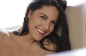 Latina pornstar Carolina Abril strips off her white bra and panties on dollser.com