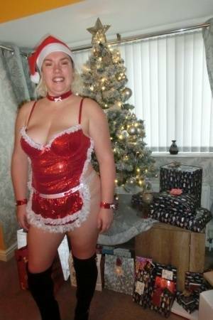 Busty blonde Barby masturbates her shaved pussy near the Christmas tree on dollser.com