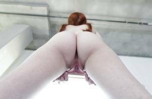 Young redhead Dolly Little revealing shaved pussy in pigtails and socks on dollser.com