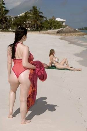 Plump female Christy Mark and her big boobed friend have lesbian sex on beach on dollser.com