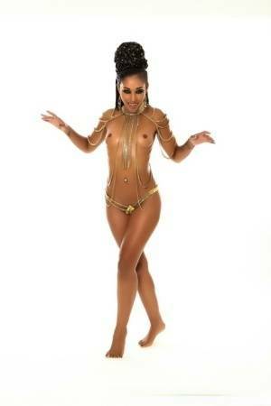 Scary ebony MILF Skin Diamond shows her fangs while posing her hot naked body on dollser.com