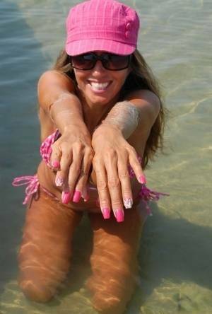 Amateur model Lori Anderson shows her hairy arms while wearing a bikini on dollser.com