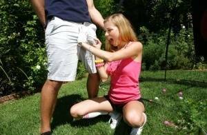 Young blonde girl Nicole Ray giving large dick oral sex outdoors on lawn on dollser.com