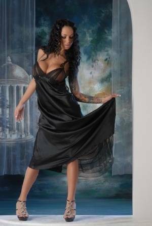 Leggy Latina chick Angelina Valentine removes a long black dress to pose nude on dollser.com
