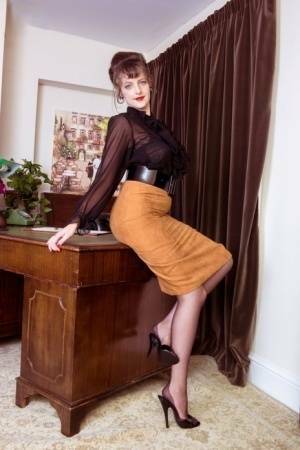 Long legged Kate Anne poses on the desk flaunting her vintage silk stockings on dollser.com