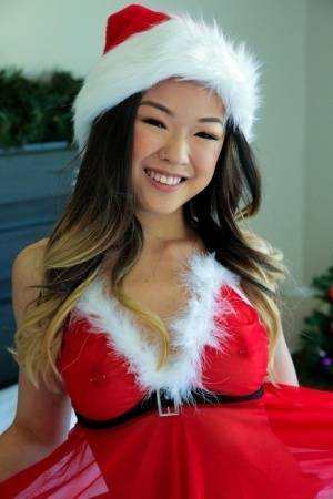 Cute Asian teen Lulu Chu wears Xmas lingerie during sex on a bed on dollser.com
