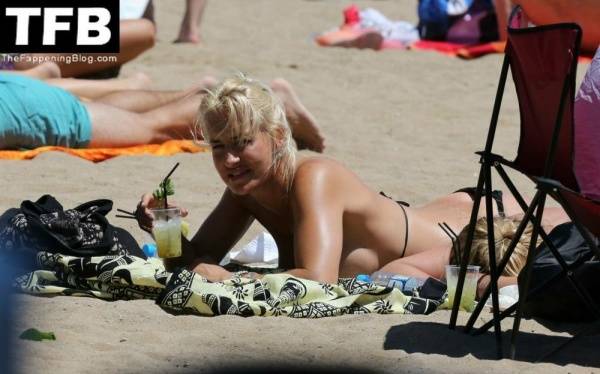 Sarah Connor Flashes Her Nude Breasts on the Beach on dollser.com