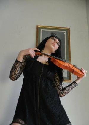Dark haired violin player Sam Bentley strikes great poses while getting naked on dollser.com