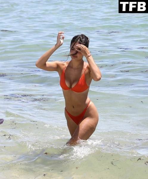 Tao Wickrath Stuns in Small Orange Bikini on the Beach in Miami on dollser.com