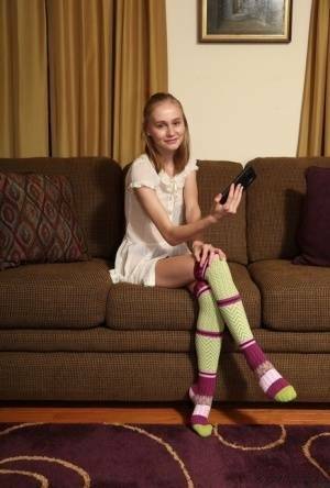 Adorable teen Alicia Williams takes a selfie before getting naked in OTK socks on dollser.com