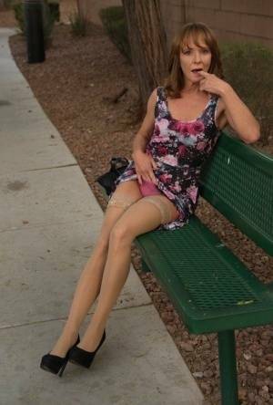 Aged lady flashes her tits and twat on a public bench before disrobing at home on dollser.com