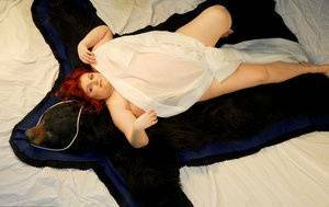 Fat redhead Black Widow AK models totally naked on a bearskin rug on dollser.com