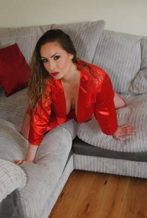 Busty amateur Sophia Delane rubs her cunt on a sofa in a robe and mesh hosiery on dollser.com