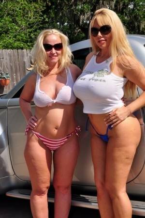 Busty blonde Dee Siren and her big titted girlfriend get fucked in a driveway on dollser.com