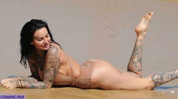 Jemma Lucy showing her ass and cleavage on the beach on dollser.com