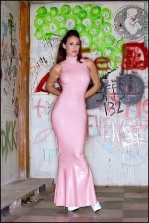 Latina beauty Ryan Keely inserts a vibrator after removing a long latex dress on dollser.com